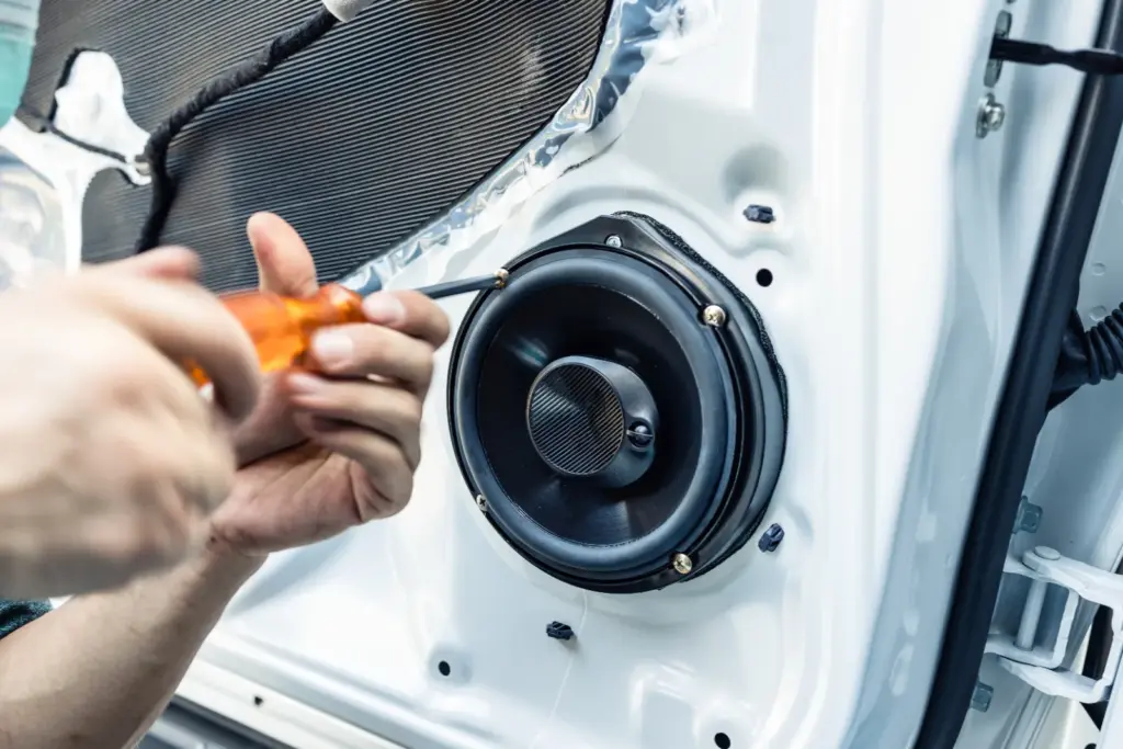 Installer wiring an aftermarket stereo in a pickup truck