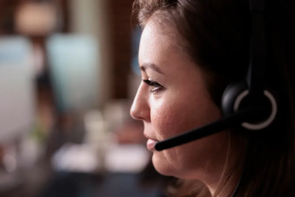 Employee answering a business call on a smartphone app in a warehouse